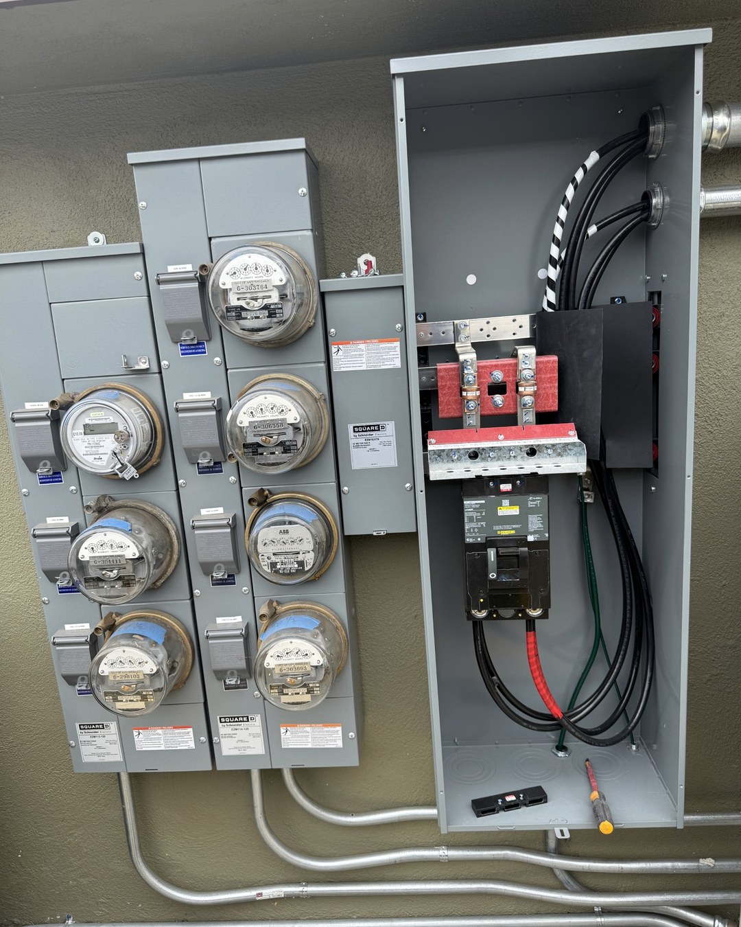 Commercial meter bank and adjacent electrical service equipment from a Bravo project.