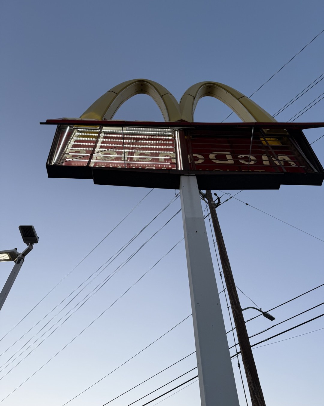 Open commercial arch sign structure showing its internal lighting.