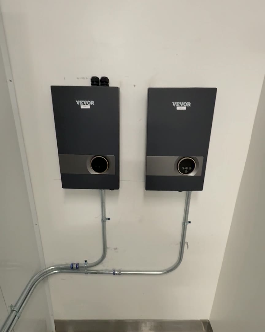 Two wall-mounted electric tankless water heaters with dedicated metal conduit feeds.