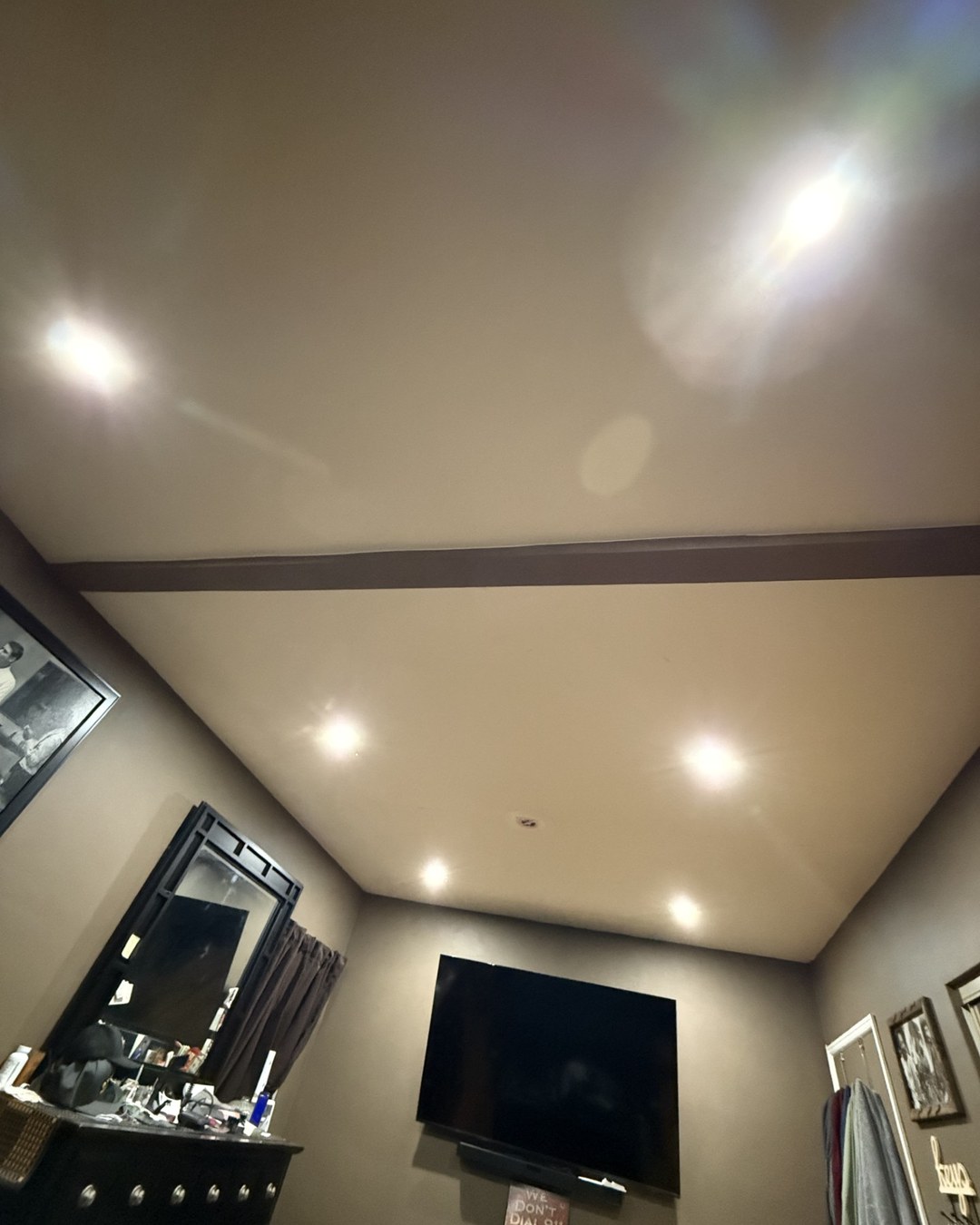 Warm modern living room at dusk lit by newly installed recessed lighting and pendant fixtures